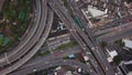 Cars driving on bridge roads shaped curve highways with skyscraper buildings. Aerial view of Expressway Bangna, Klong Toey in