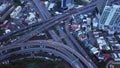 Cars driving on bridge roads shaped curve highways with skyscraper buildings. Aerial view of Expressway Bangna, Klong Toey in