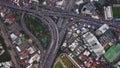 Cars driving on bridge roads shaped curve highways with skyscraper buildings. Aerial view of Expressway Bangna, Klong Toey in