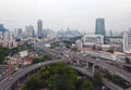 Cars driving on bridge roads shaped curve highways with skyscraper buildings. Aerial view of Expressway Bangna, Klong Toey in