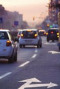 Cars driving on busy city road at dusk Royalty Free Stock Photo