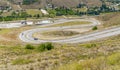 Cars driving on curved, zigzag road or street on hill from Imrahor Valley just near Muhye Village to Cankaya, Simpas houses. Royalty Free Stock Photo