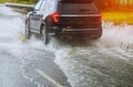 cars driving on a flooded road during a flood caused by heavy rain Royalty Free Stock Photo