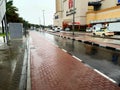 Cars driving through the flooded streets in Dubai during rain. Heavy rain in UAE and puddles. Rainy in desert Royalty Free Stock Photo