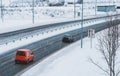 Cars driving on a snow covered road during a snow storm