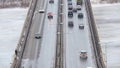 Cars driving on snowy road in winter, traffic driving on the bridge, highway