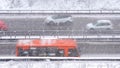 Cars driving on snowy road in winter, traffic on highway in snowfall, blizzard