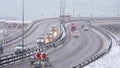 Cars driving on snowy road in winter, traffic on highway in snowfall, blizzard