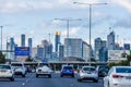 Cars driving towards the city CBD with road signage to Melbourne Airport