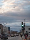 Cars driving in a traffic jam on Saint Laurent Boulevard in Montreal, Quebec, in the evening, with a plane landing in background Royalty Free Stock Photo