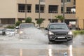 Cars driving trough big water pond after heavy rains fall in Dubai