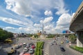 Cars driving at Victory Monument with busy street road. Roundabout in Bangkok Downtown Skyline. Thailand. Financial district