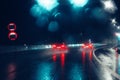 Cars with red lights driving on wet road during heavy rain. Night highway bad weather Royalty Free Stock Photo