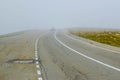 Cars in fog on the Transalpina road DN67C. This is one of the most beautiful alpine routes in Romania