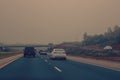 Cars on freeway road at evening in city country.