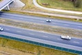 Cars and freight semi truck driving on busy highway across the country in beautiful summer evening. People on road trip traveling Royalty Free Stock Photo