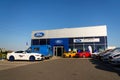 Cars in front of Ford motor company dealership building