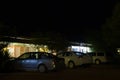 Cars in front of a motel at night