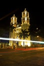 Cars going by Cathedral of San Gervasio in Valladolid, Mexico