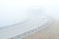Cars on highway in fog with covered bridge Royalty Free Stock Photo