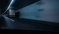 Cars on a highway going through a long modern tunnel