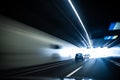 Cars on a highway going through a long modern tunnel