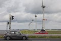 Cars at highway passing big windturbines near Dutch lake IJsselmeer