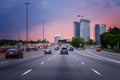Cars on highway road at sunset evening in typical busy american Canadian  city Royalty Free Stock Photo