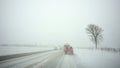 Cars on highway by snowstorm Royalty Free Stock Photo