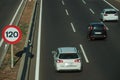 Cars on highway and SPEED LIMIT signpost in Madrid