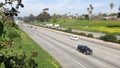 Cars on interstate highway California USA. Intercity freeway transport. Road traffic and greenery. Royalty Free Stock Photo