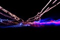 Cars light trails on a curved highway at night. Night traffic trails. Motion blur. Night city road with traffic headlight motion. Royalty Free Stock Photo