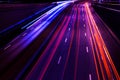 Cars light trails on a curved highway at night. Night traffic trails. Motion blur. Night city road with traffic headlight motion. Royalty Free Stock Photo