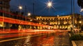 Cars light trails in the evening square in Rome right after the rain. Night traffic routes. Motion blur. Cityscape Royalty Free Stock Photo