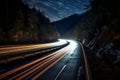 Cars light trails at night in a curve asphalt road at night. Long exposure image of a highway at night