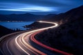 Cars light trails at night in a curve asphalt road at night. Long exposure image of a highway at night