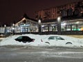 Cars on a Moscow street at night covered with a thick layer of snow.