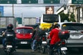 Cars, motorcycles and other vehicles travel along a traffic congested road