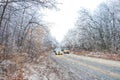 Cars move in winter snowy driving journey on forest road