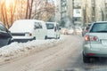 Cars moving on city street on slippery snowy road winter. Vehicles covered with snow drift snowfall blizzard cold winter Royalty Free Stock Photo