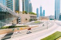 Cars moving on street among glass skyscrapers in Dubai. Traffic on street in Dubai. Cars moving at street. Modern with