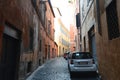 Cars parked along empty street Trastevere, Rome