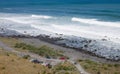 Cars parked at the bottom of the Cape Palliser Lighthouse in New Zealand Royalty Free Stock Photo