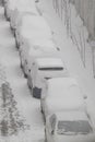 Cars parked near the house covered with snow. Vertical photo. Snowy winter in the city Royalty Free Stock Photo