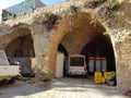 Cars parked near old stone arches in Akko, Israel.