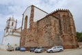 Cars parked outside of the Silves Cathedral in Silves, Portugal.