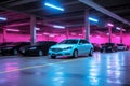 cars parked in a parking garage with neon lights