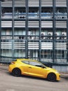 Cars parked on the road against a background of a modern building