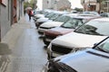 Cars parked in a row on a city street Royalty Free Stock Photo