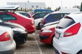 Cars parked in a row in an open parking lot.